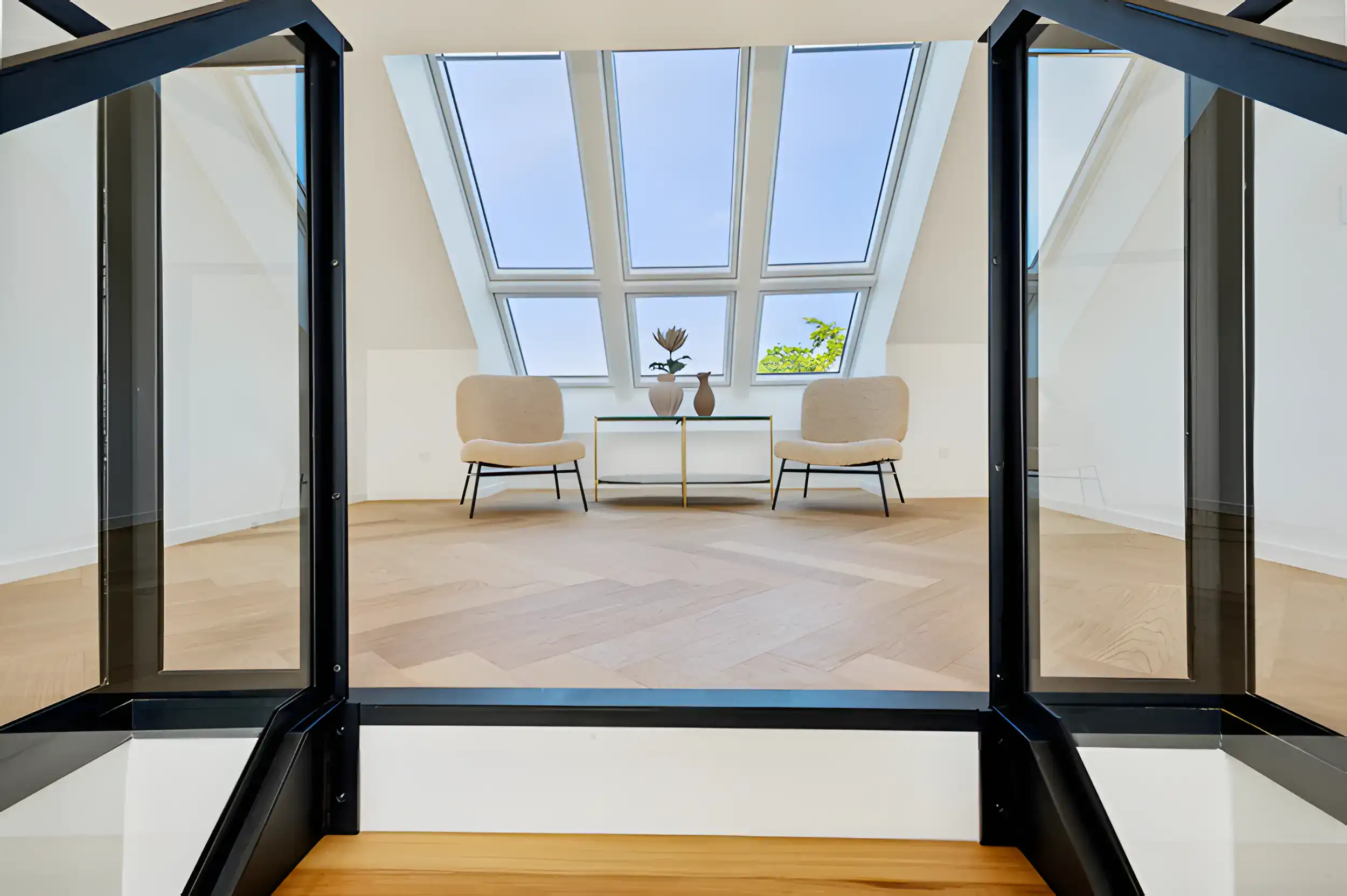 Moderne hjemmekontor med store vinduer og komfortable stole.